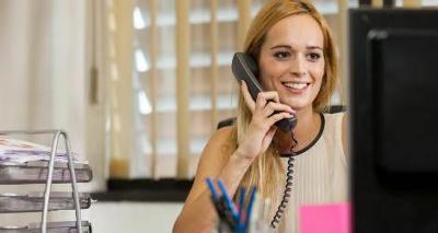 Photograph of an adult using a telephone