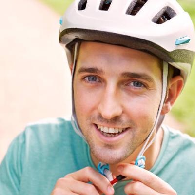 Adult cyclist clipping helmet on