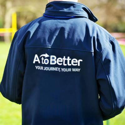 The back of a person wearing an AtoBetter jacket 