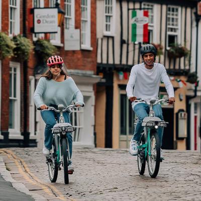 Two people riding Beryl bikes 