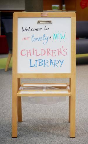 Whiteboard sign that reads ‘Welcome to our lovely and new Children’s Library’ 