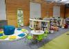 Seating areas including cushions, a beanbag, stools and table with chairs 
