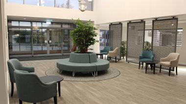 Reception area with armchairs and tables at Swallowtail Place