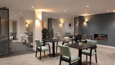 Communal dining area with tables and chairs at Swallowtail Place 