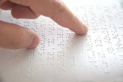 A hand reading braille