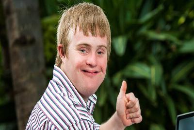 Person smiling with thumbs up