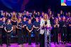 Sara Tough OBE and the Echoes of the East choir on stage