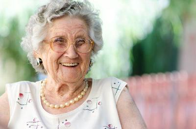 A smiling older lady posing for the camera
