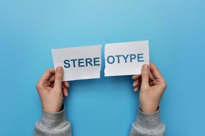 The word stereotype written on a piece of paper being torn in two