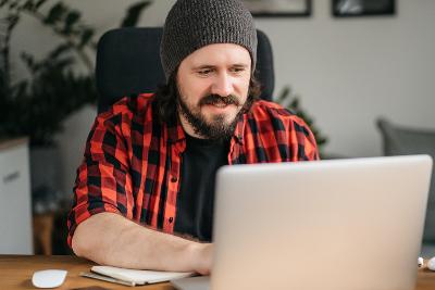A man typing on a laptop
