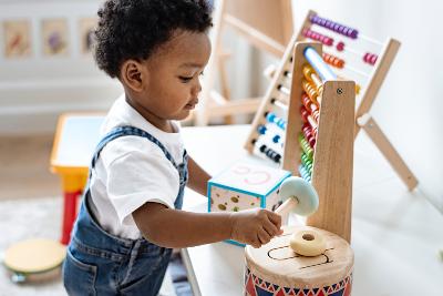 Child playing with toys in a nursery setting