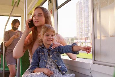 Photograph of adult and child on a bus
