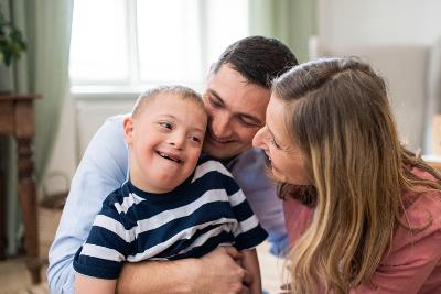Parents cuddling a small boy age about 3