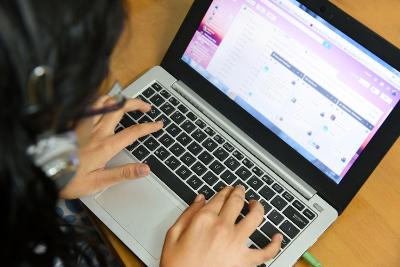 A person typing on a laptop computer