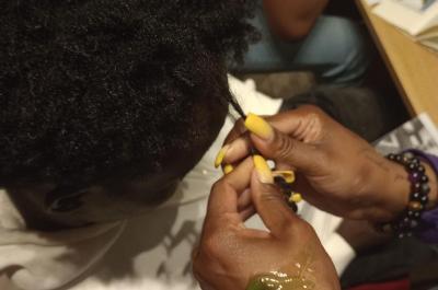 Hair being tended to in close up