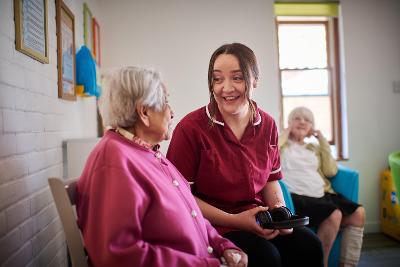 Healthcare professional speaking to person