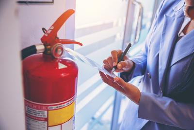 Someone checking fire extinguisher