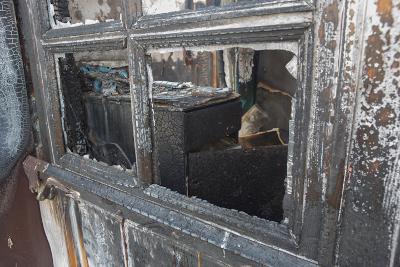 Charred window of a burnt house