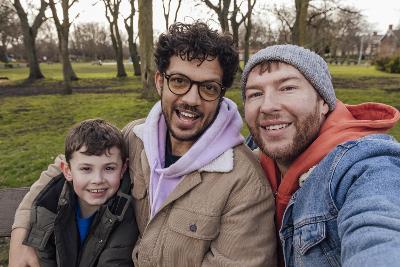 Photograph of two adults with a child