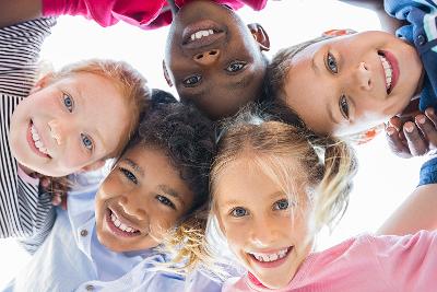 A group of schoolchildren looking into the camera from above