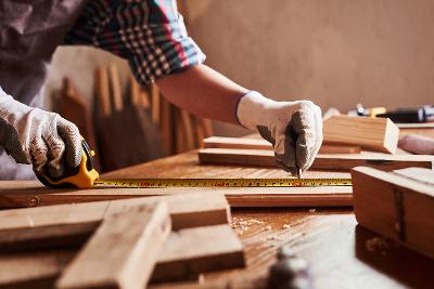 Worker using a tape measure