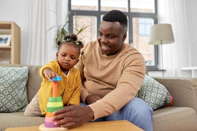 Parent and child playing with a toy