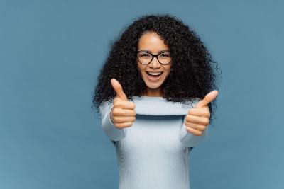 Person smiling with thumbs up